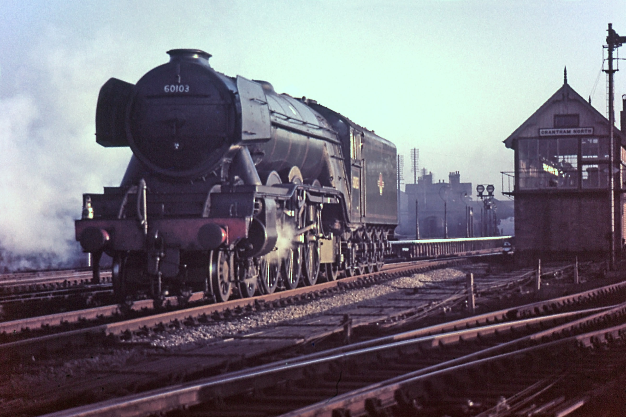 A gleaming No.60103 Flying Scotsman moves forward past Grantham North box in 1962 ...but notice too the glint of the low sun on the lever tops, regularly polished by the Telegraph Lads. Photograph by Noel Ingram, used with permission from Steam World.