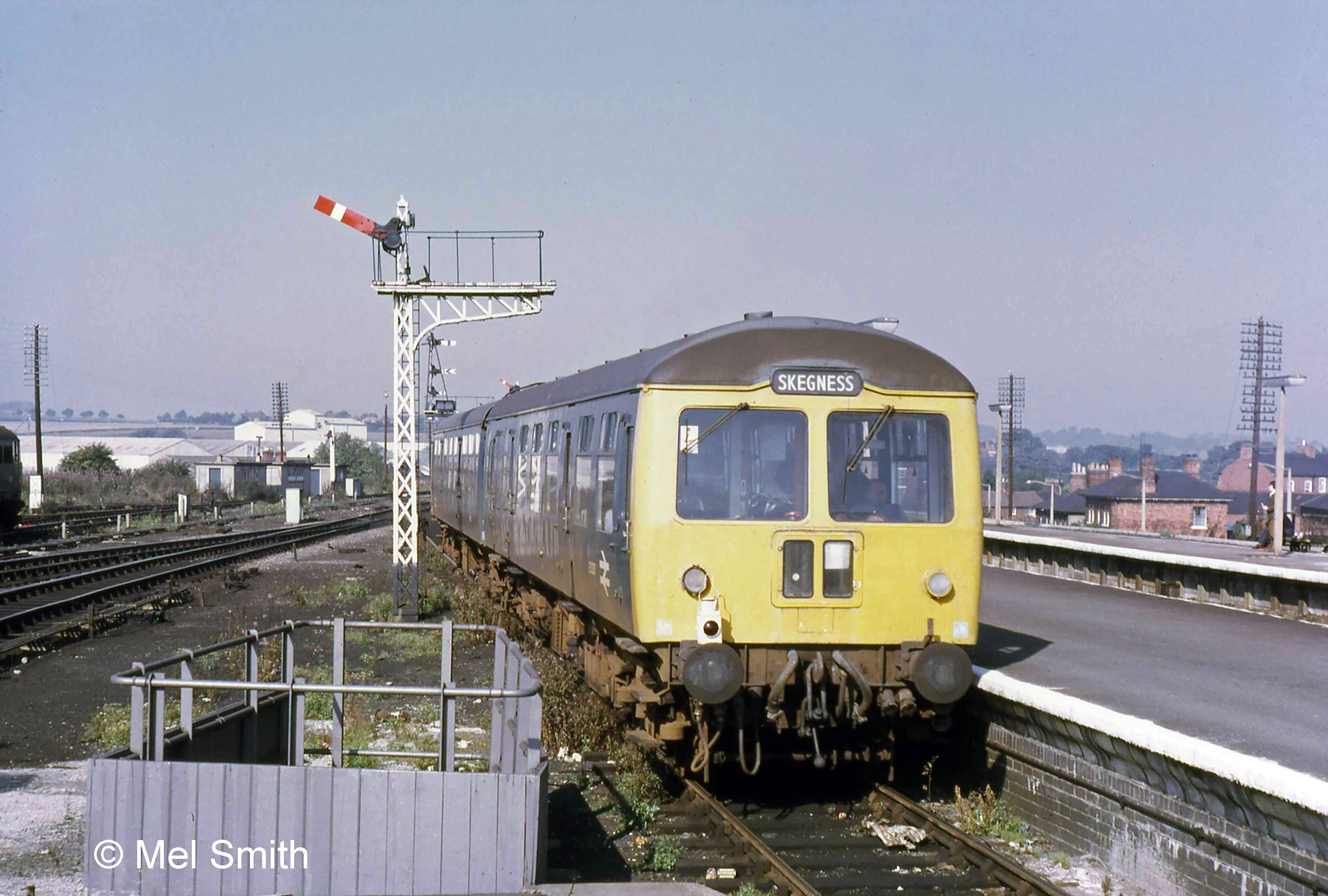 Leaving the Down Bay platform for Skegness in October 1971 this train would, in former days, have taken the connection to the Down Main line at this point. As can be seen, with the removal of the Main line signal post which had been fixed on the overhanging end of the bracket, this is no longer possible. The new connection at Barrowby Road will enable this train to reach Barkston South Junction, where it will turn off the Main line. In 2005 a connection opened at Allington, a few miles out of Grantham on the Nottingham line. Thereafter trains between Grantham and East Lincolnshire no longer used the Main line, and Barkston ceased to be a junction. Photograph by Mel Smith.