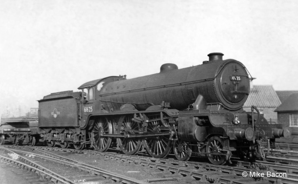 Class B17/1 No. 61625 Raby Castle is far from its home shed of Ipswich with a freight train at Grantham's Down side goods yard Photograph by Mike Bacon.