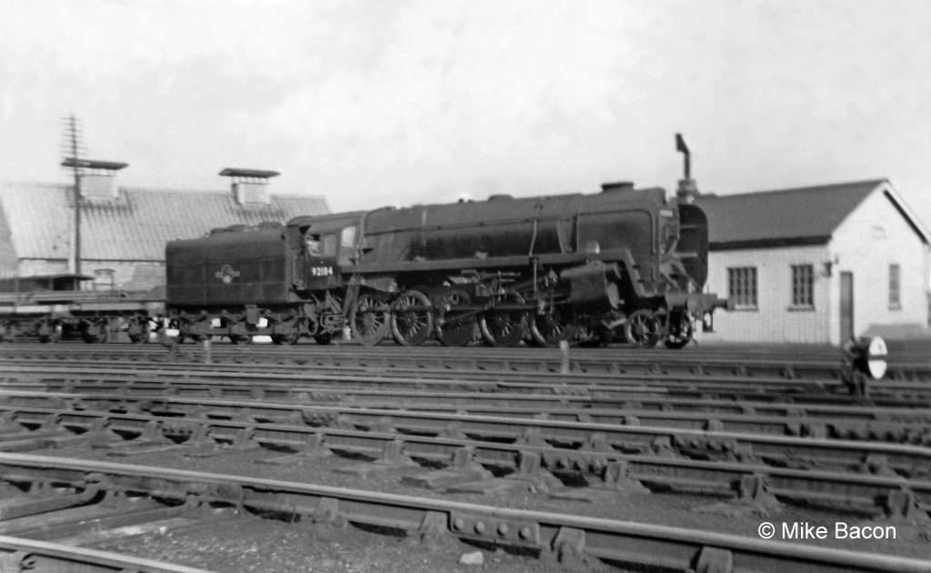 BR Standard Class 9F heavy freight locomotive No. 92184 with a southbound freight, photographed from the wall near Springfield Road bridge. Photograph by Mike Bacon.