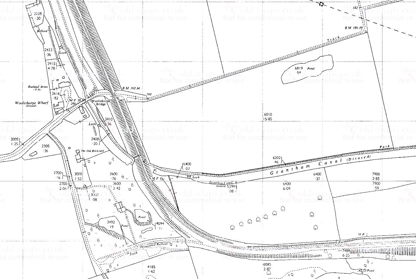 The bridge near Woolsthorpe Wharf on the Grantham canal and the former bridge over the canal. To the west of the branch as it begins to curve after crossing the canal there was once a brickworks, which ws served by a siding marked 'Dismantled Railway'.