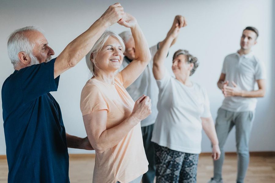 Older people dancing with their partners on a dancing course