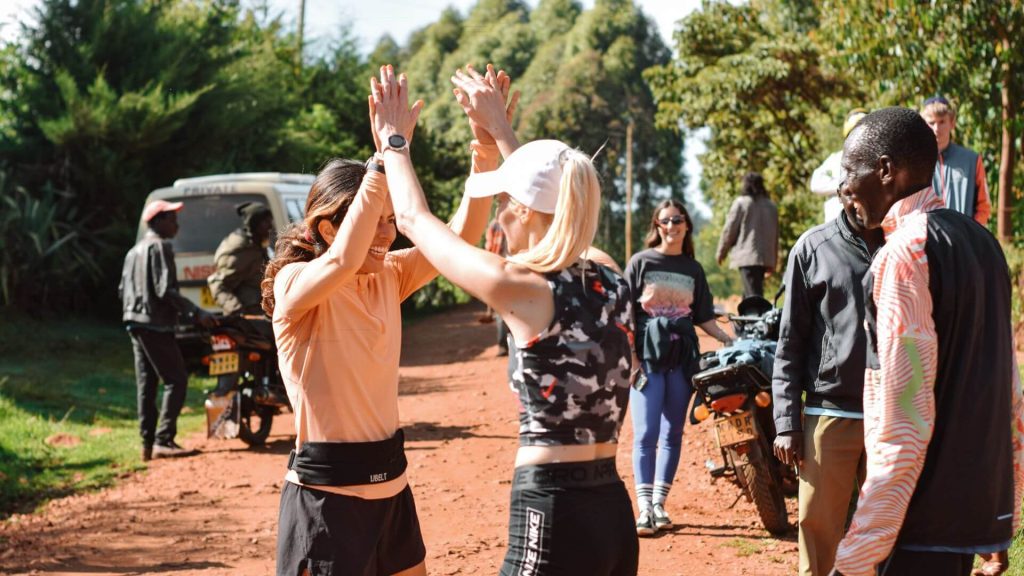 Two runners celebrating by clapping hands after running in Singore forest