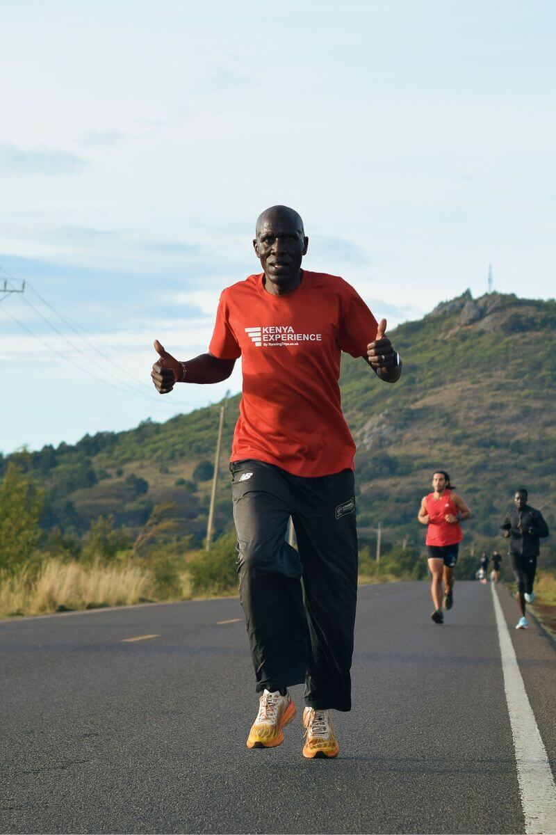 Will Songok Running on Moiben Road with the Kenyan hills behind him
