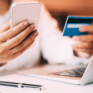 person holding mobile and a card