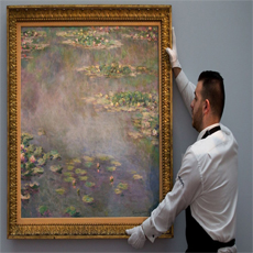 man holding a painting