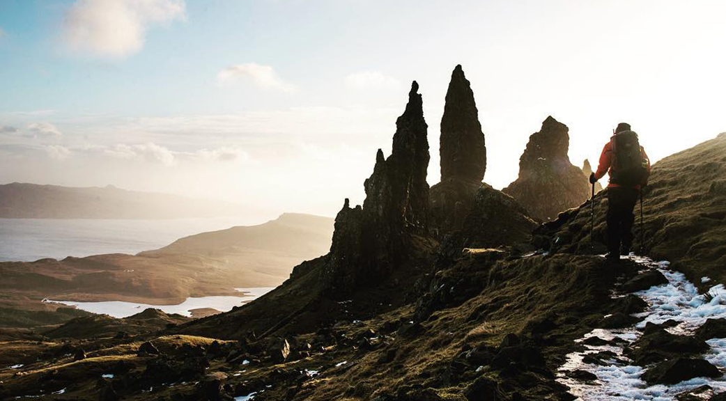 Two trekkers walk towards the Old Man of Storr in the Trotternish on Skye