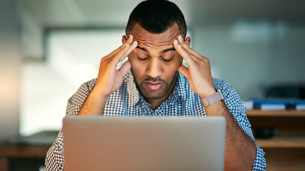man stressed at laptop