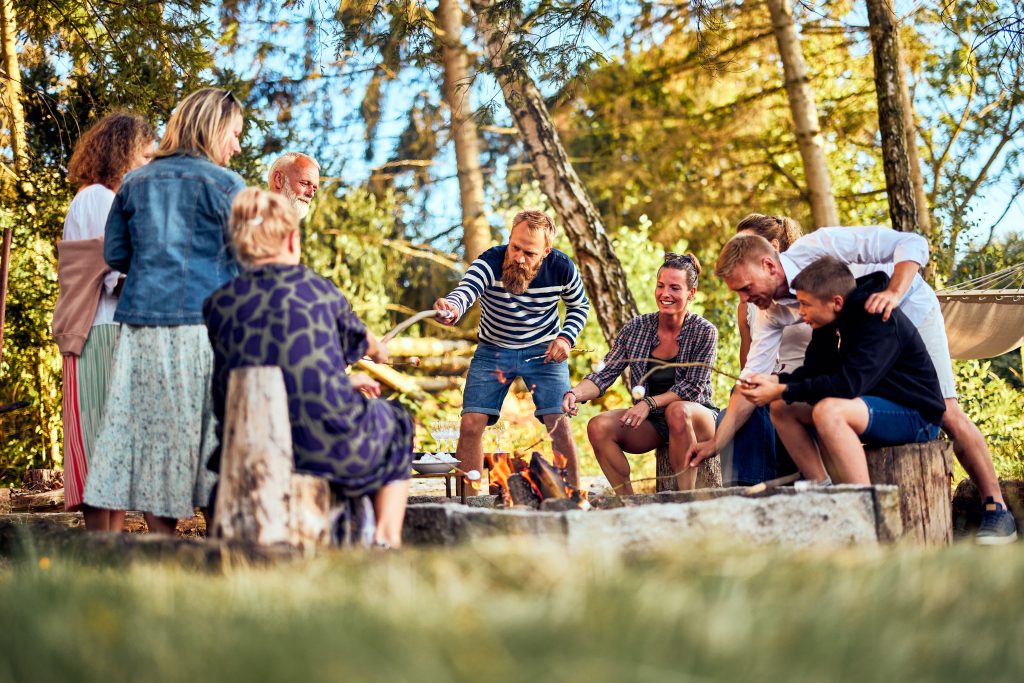 Friends and family toasting marshmallows around a campfire during a weekend getaway