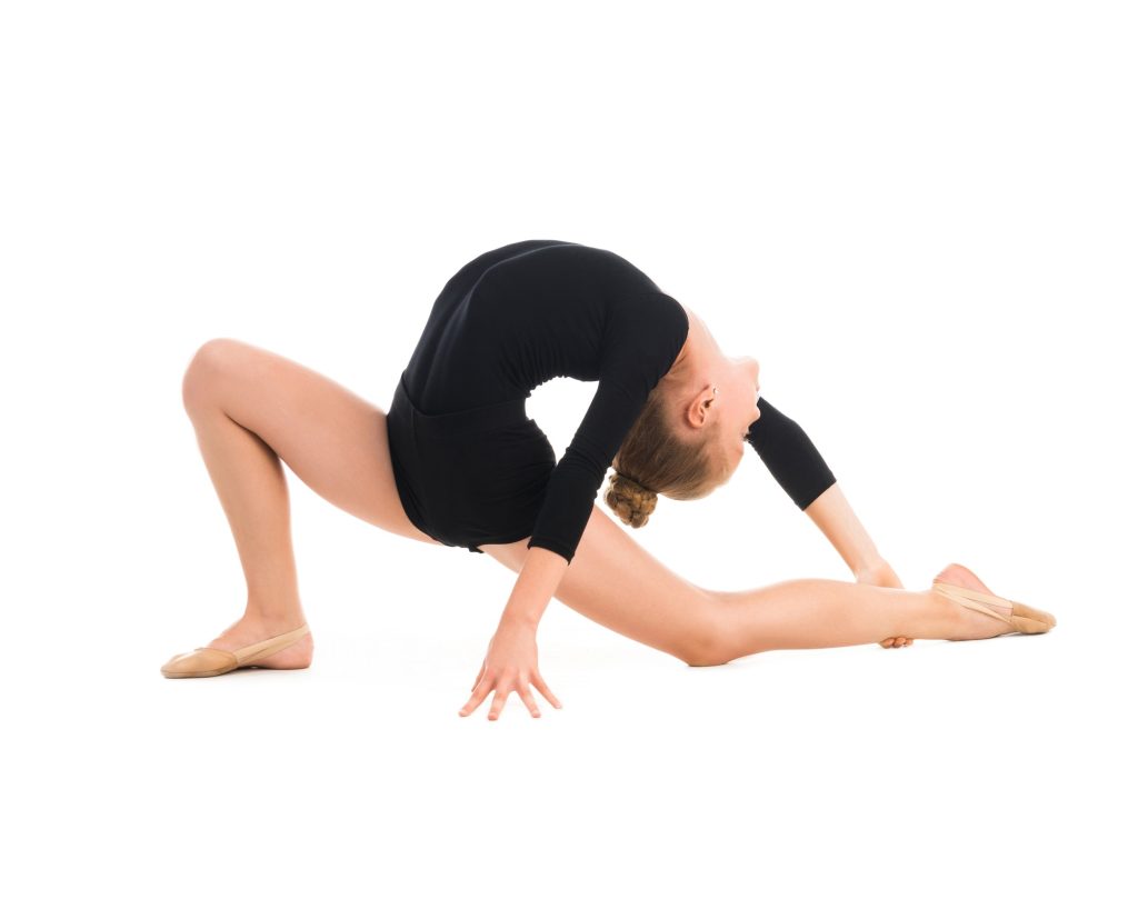 little gymnast stretching on the floor