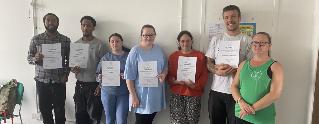 Group of young people who took part in the introduction to youth work course in May 2025, holding their certificates.