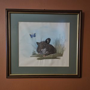 framed needle point artwork of a pouched rat.