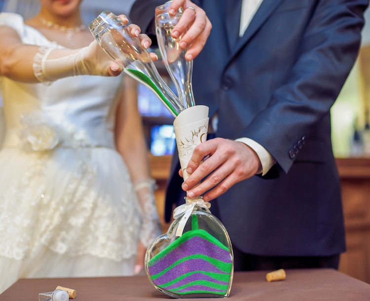 The,Bride,And,Groom,Colorful,Sand,Is,Poured,Into,The