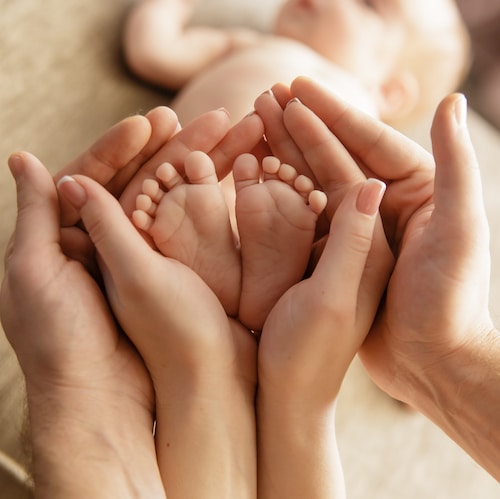 Baby feet in parent hands naming ceremony
