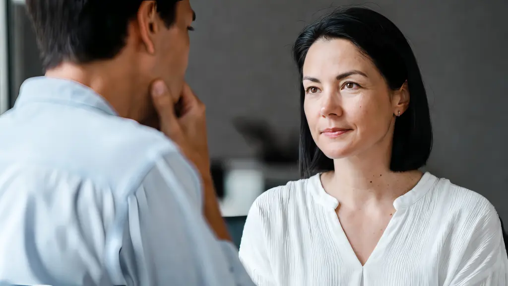 Eye contact in a therapeutic setting showing a therapist using calm, non-intrusive gaze during a counseling session
