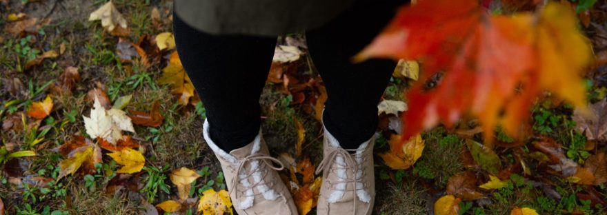 person standing on fallen leaves