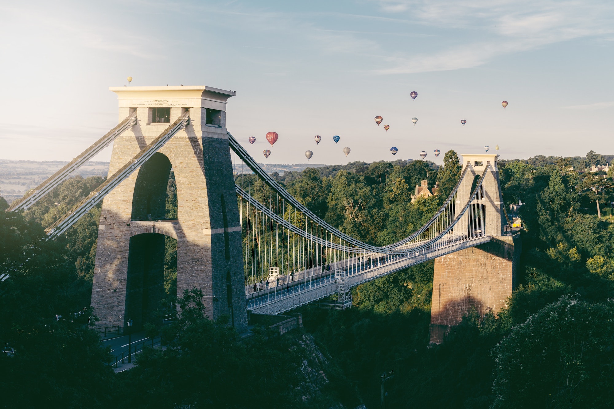 Hot air balloons flying over the Clifton Suspension Bridge in Bristol.