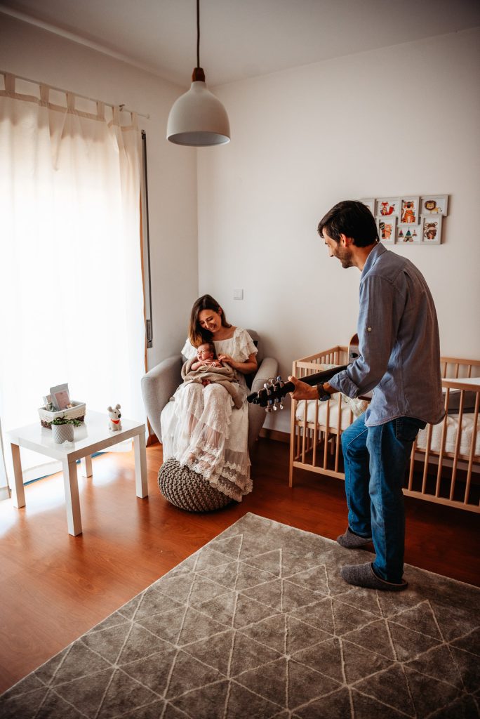 parents with new baby in the baby's bedroom