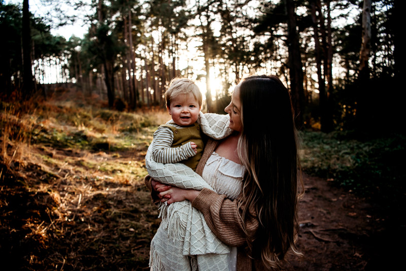 Mother and son posing in the forest for West Sussex motherhood photographer