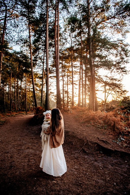 mother carrying baby at sunset for a motherhood photography session