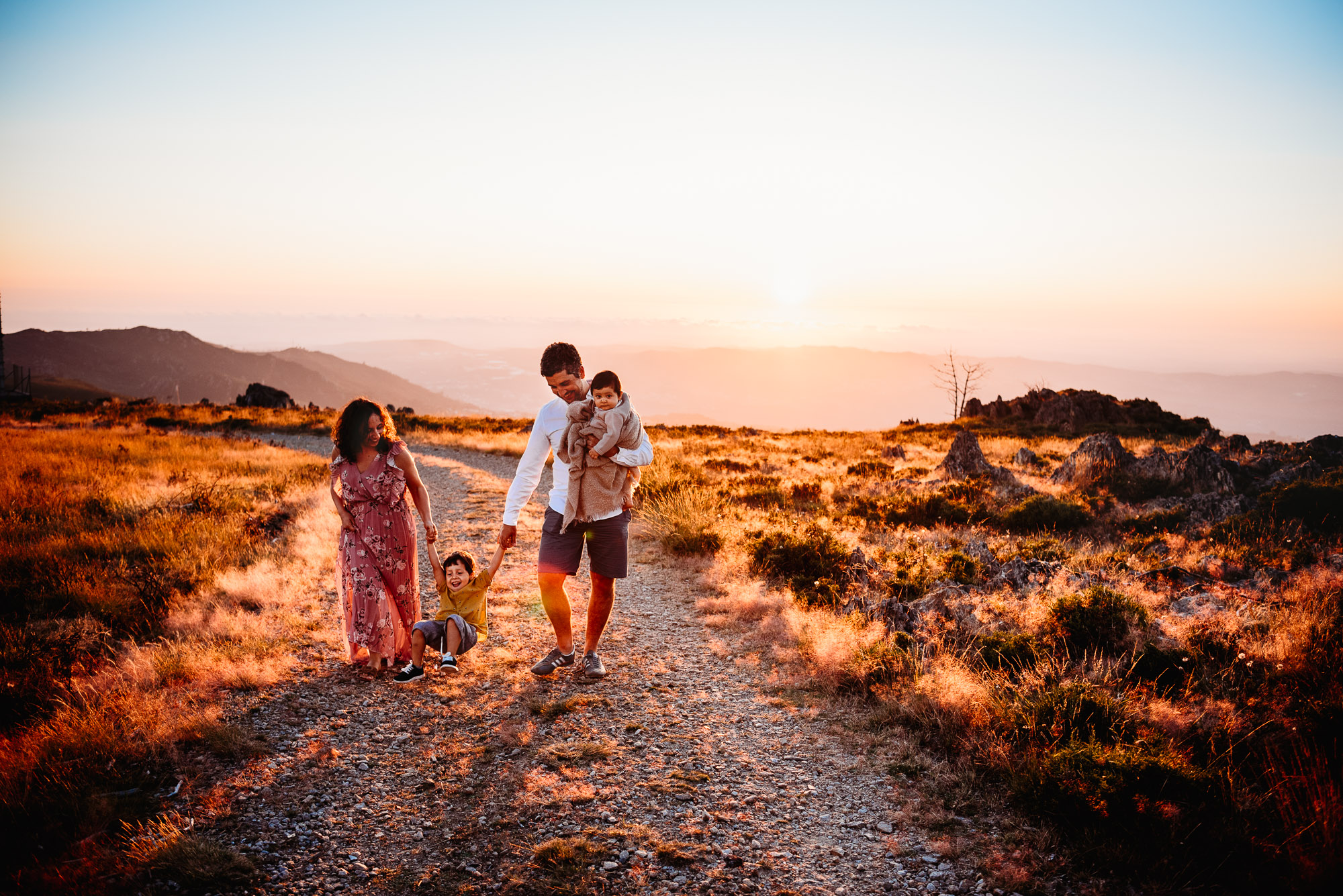 family walking with sunset behind with family photographer sussex