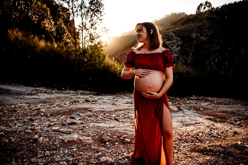 pregnant woman posing during a maternity session at sunset