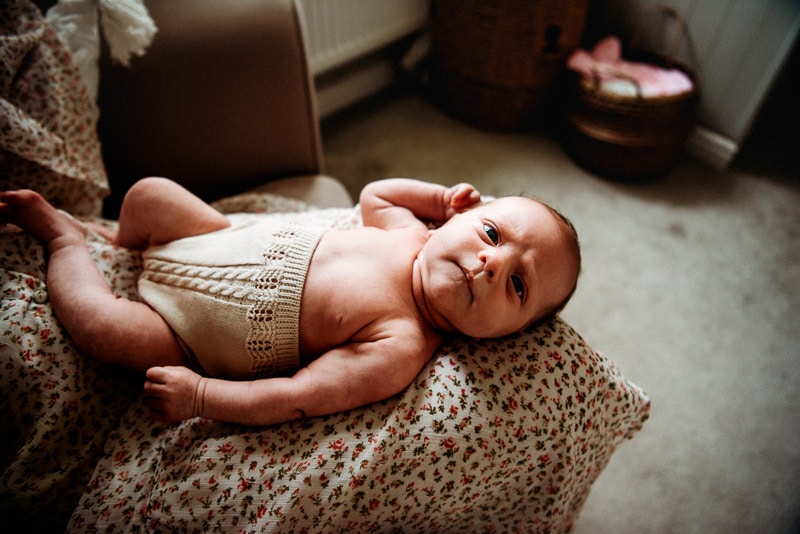 baby posing on mum's lap during a photography sessuion at sussex photographer