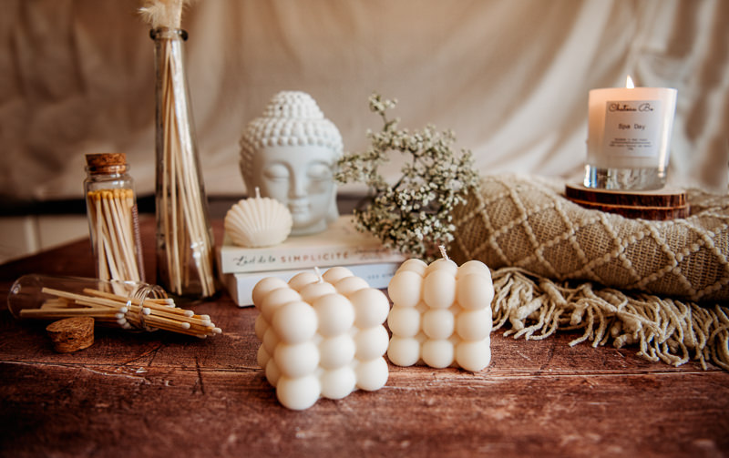 Candles, flowers and books during product photography with West Sussex branding photographer