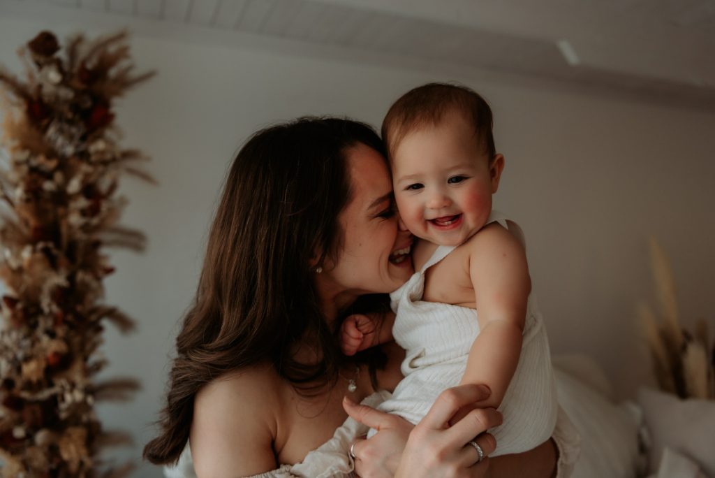 mum and baby heads together