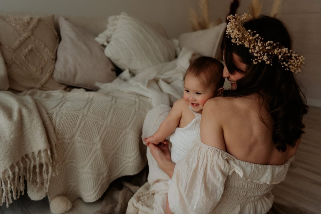 Mum and baby daughter sitting on the floor