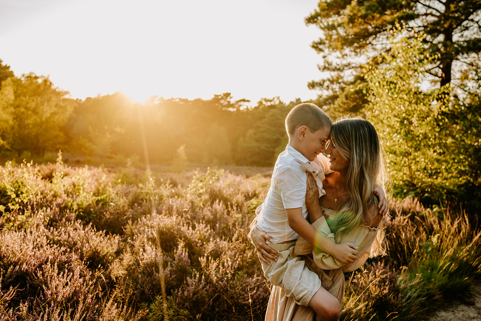 Mum touching child's head during golden hour with family photographer based in Billinsghurst, West Sussex
