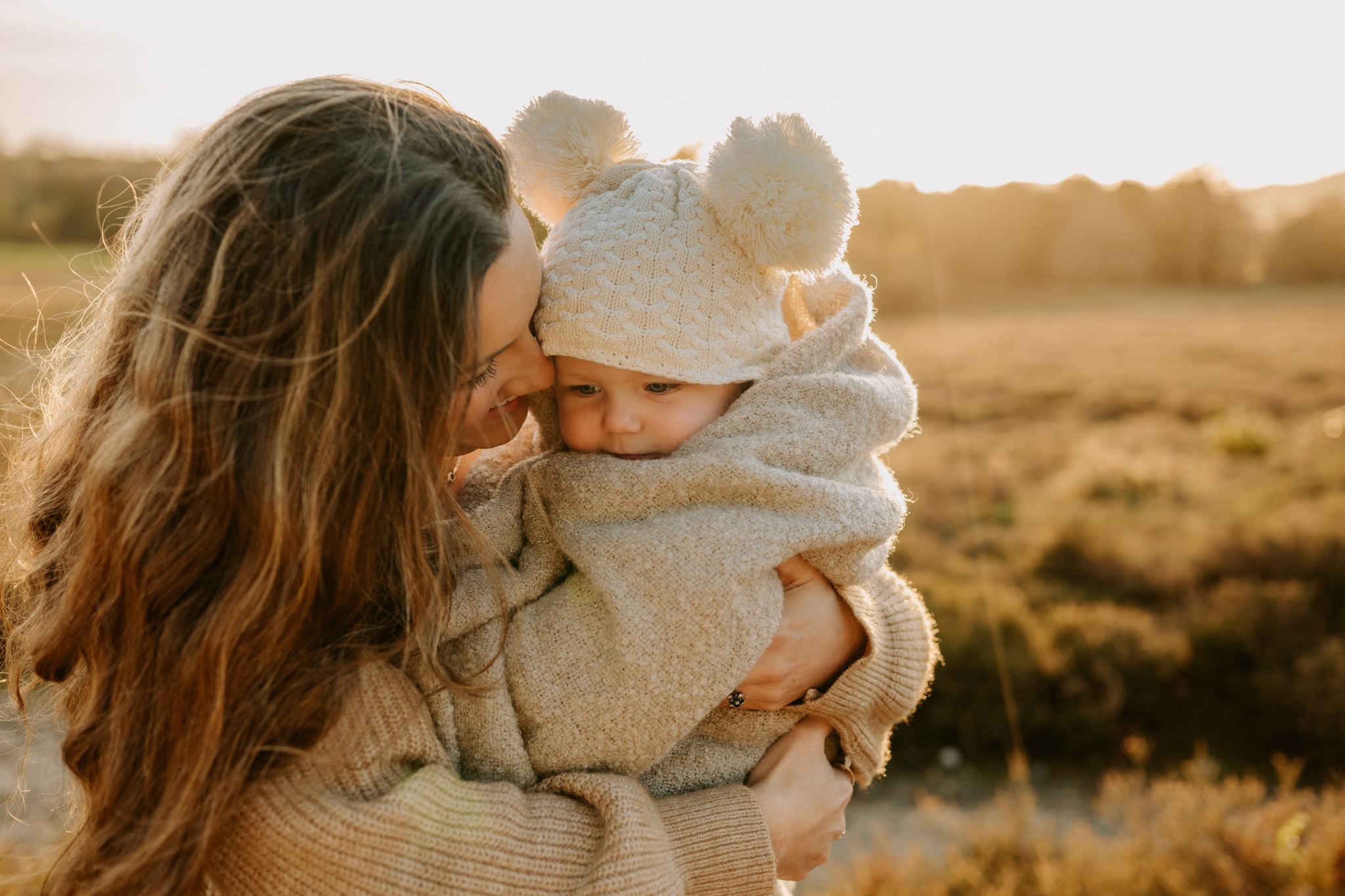 Mother and baby kissing at golden hour in Sussex