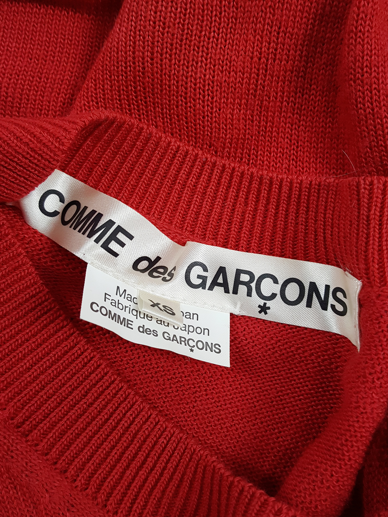 Comme des Garçons red knit top with long strips — spring 2015 