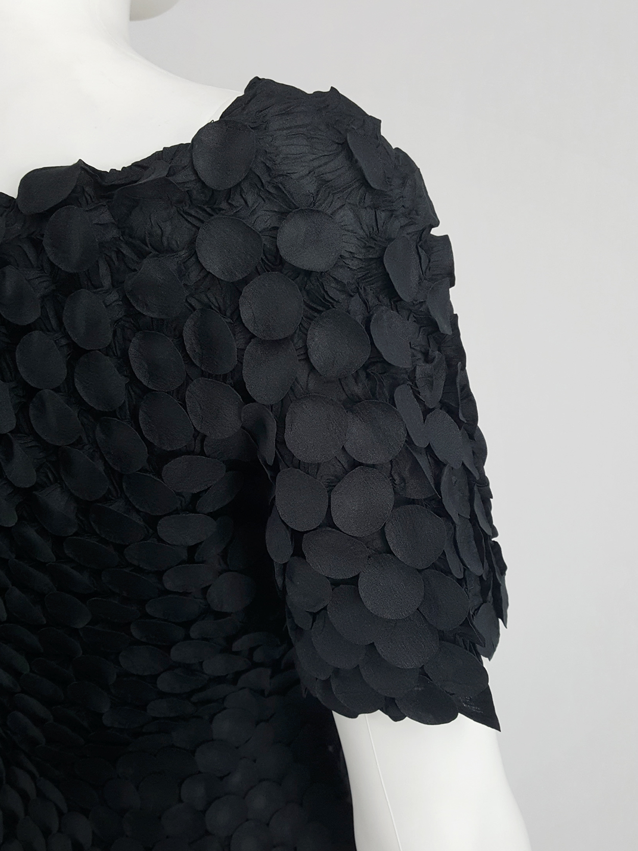 Issey Miyake black t-shirt with the fabric manipulated into 3D 