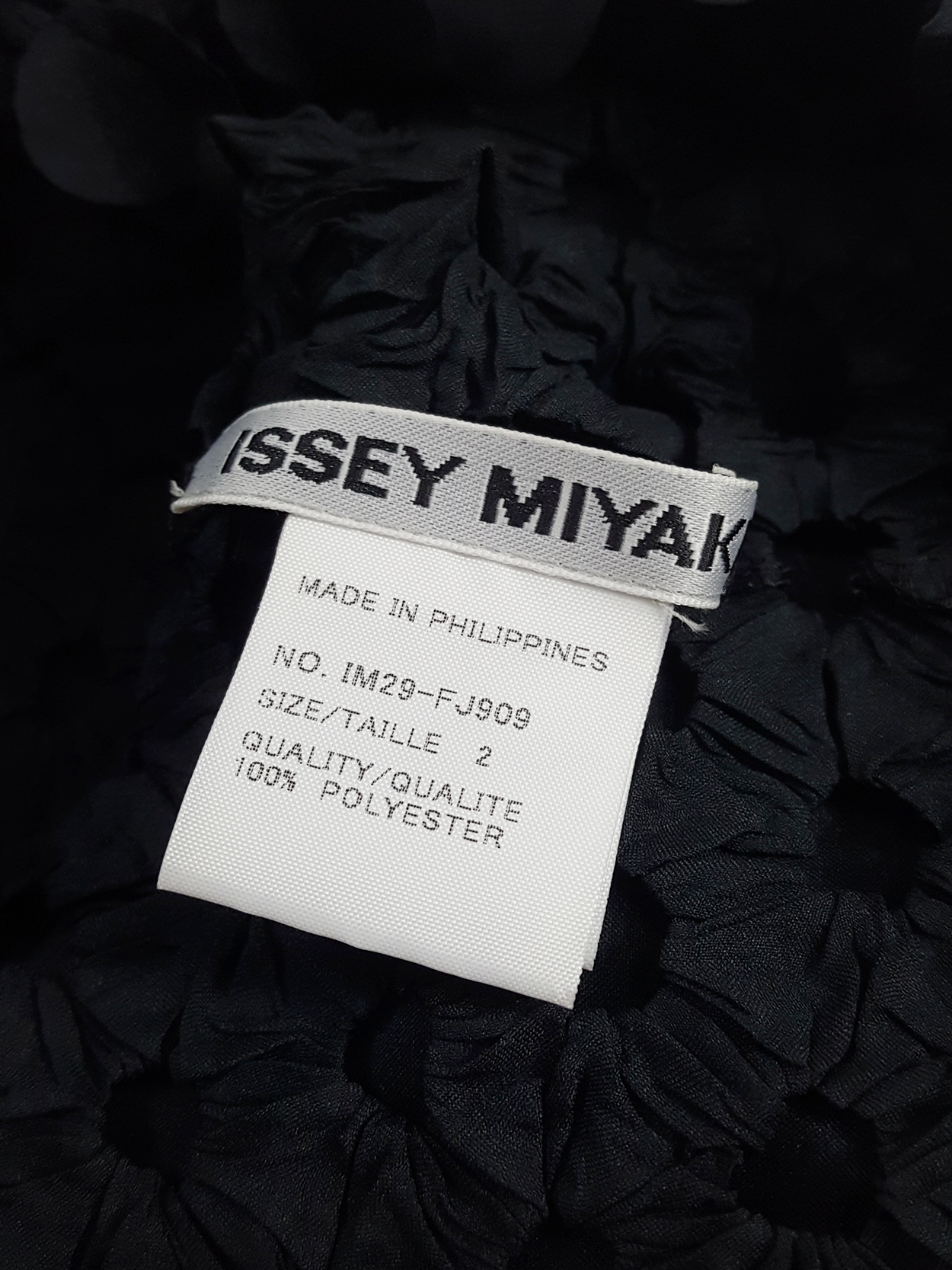 Issey Miyake black t-shirt with the fabric manipulated into 3D 