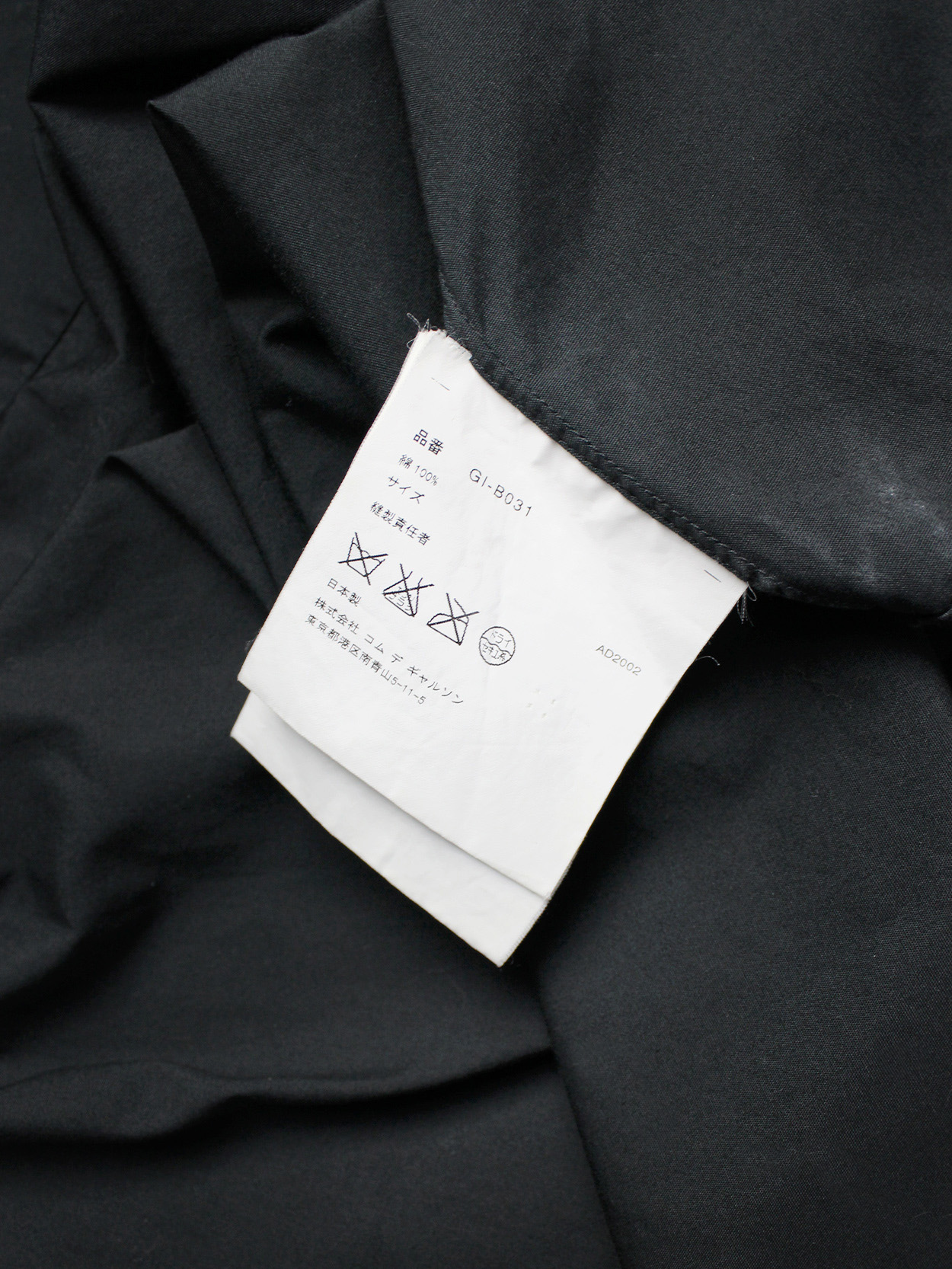 Comme des Garçons black shirt with slits and three bows — spring 