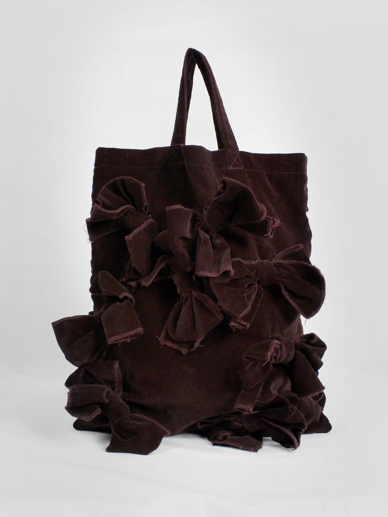 Comme des Garçons Comme burgundy velvet tote bag covered in bows 