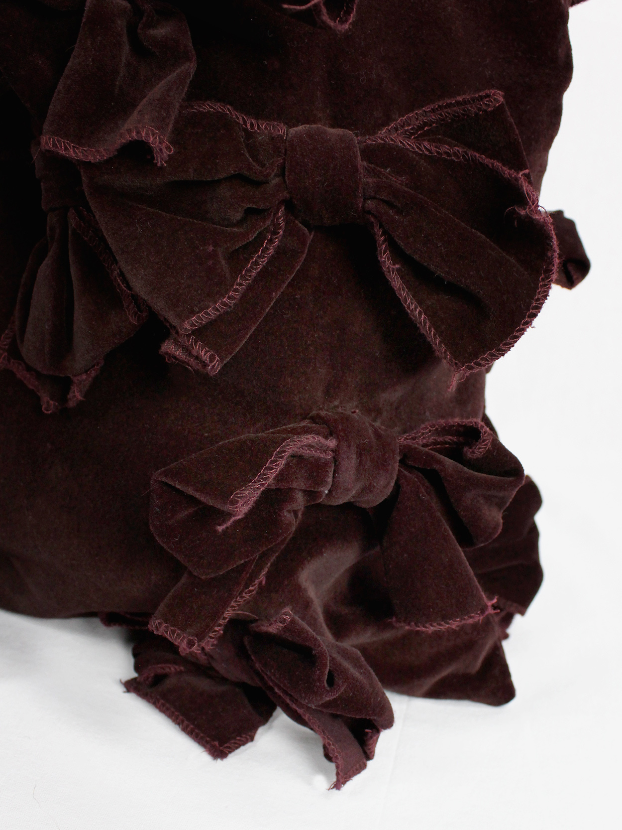 Comme des Garçons Comme burgundy velvet tote bag covered in bows 