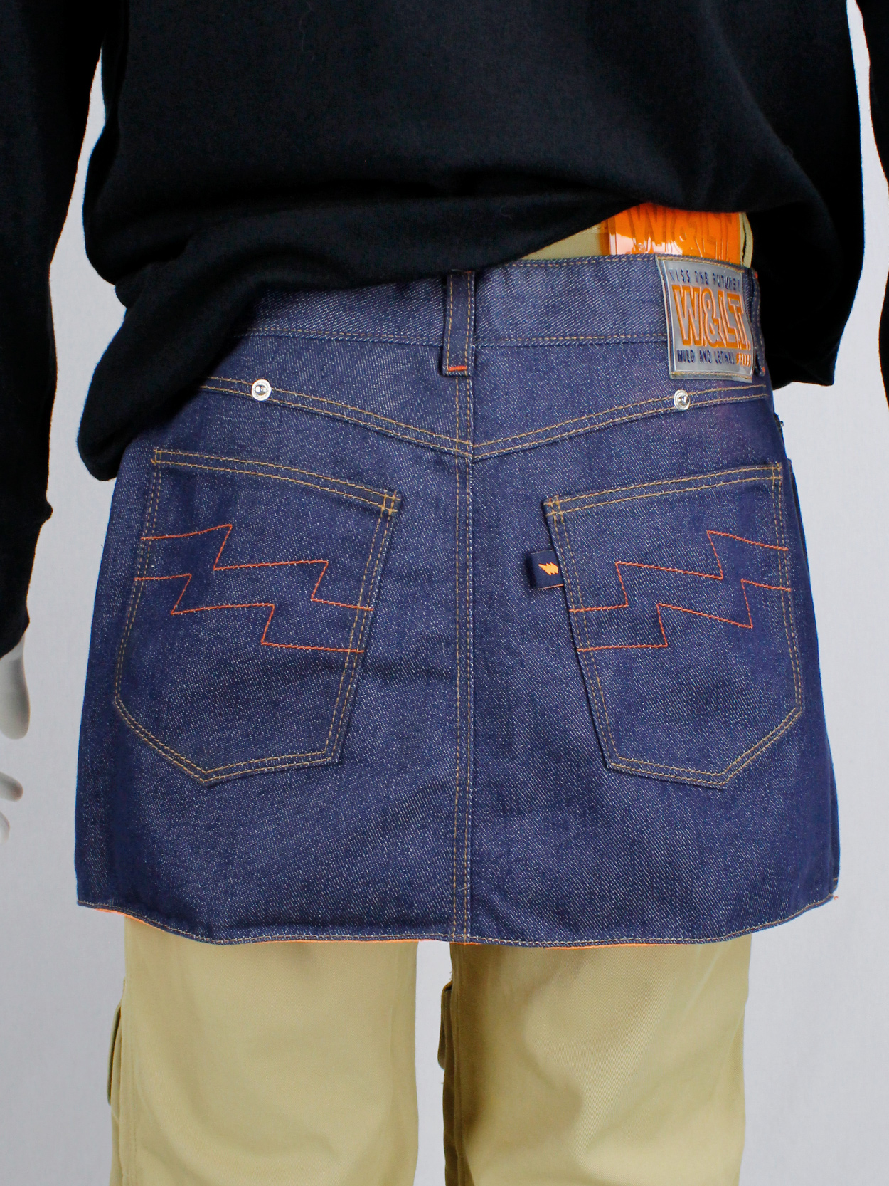 Walter Van Beirendonck W&LT denim trousers as a belt with neon 