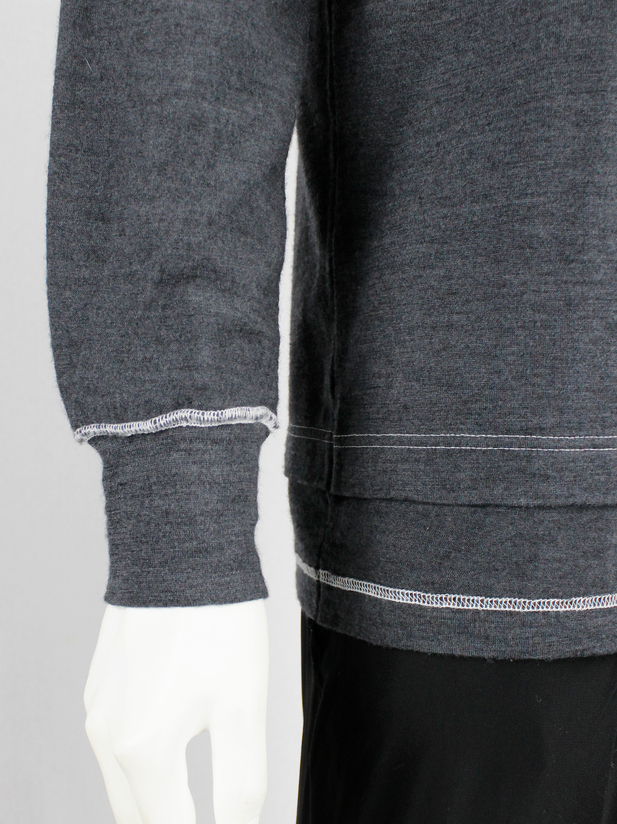 Comme des Garçons Homme grey jumper with a t-shirt layered over it 