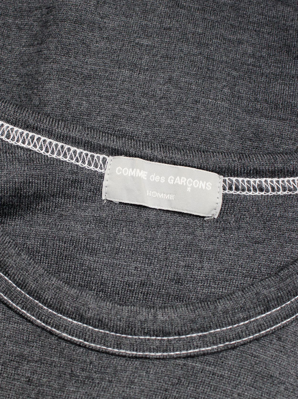 Comme des Garçons Homme grey jumper with a t-shirt layered over it 