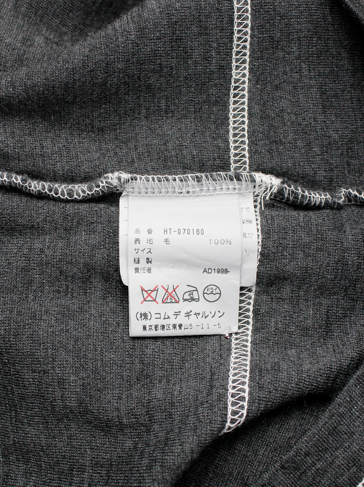 Comme des Garçons Homme grey jumper with a t-shirt layered over it 
