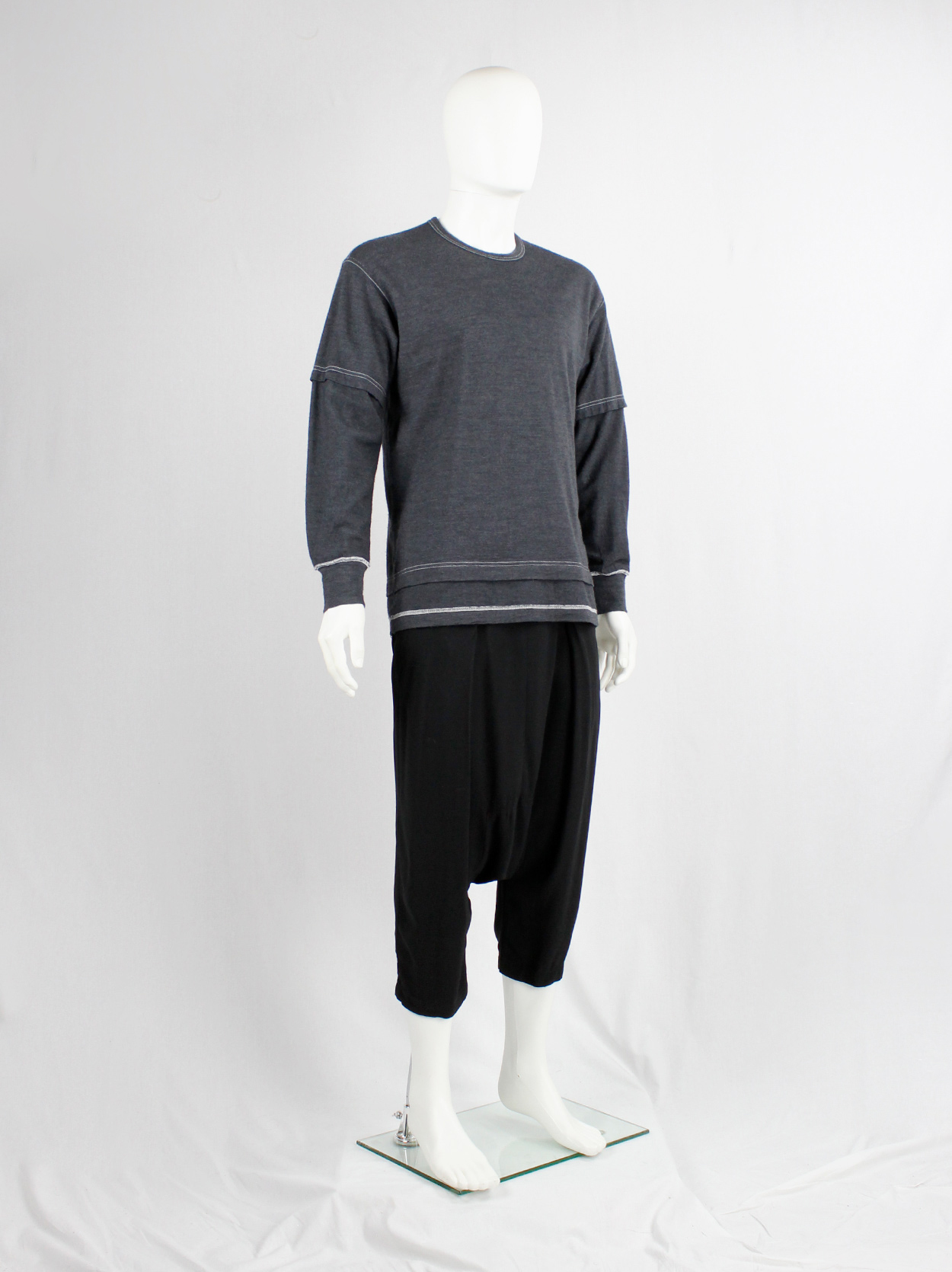 Comme des Garçons Homme grey jumper with a t-shirt layered over it 