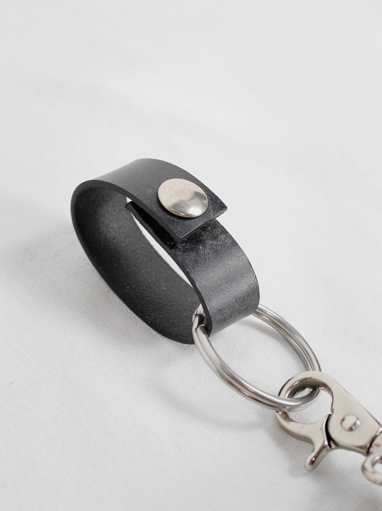 Ann Demeulemeester black large leather egg pouch attached to a key