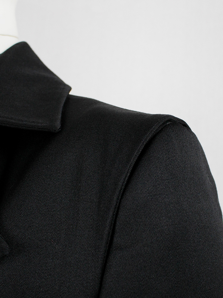 Xavier Delcour black long coat with two silver zippers going from