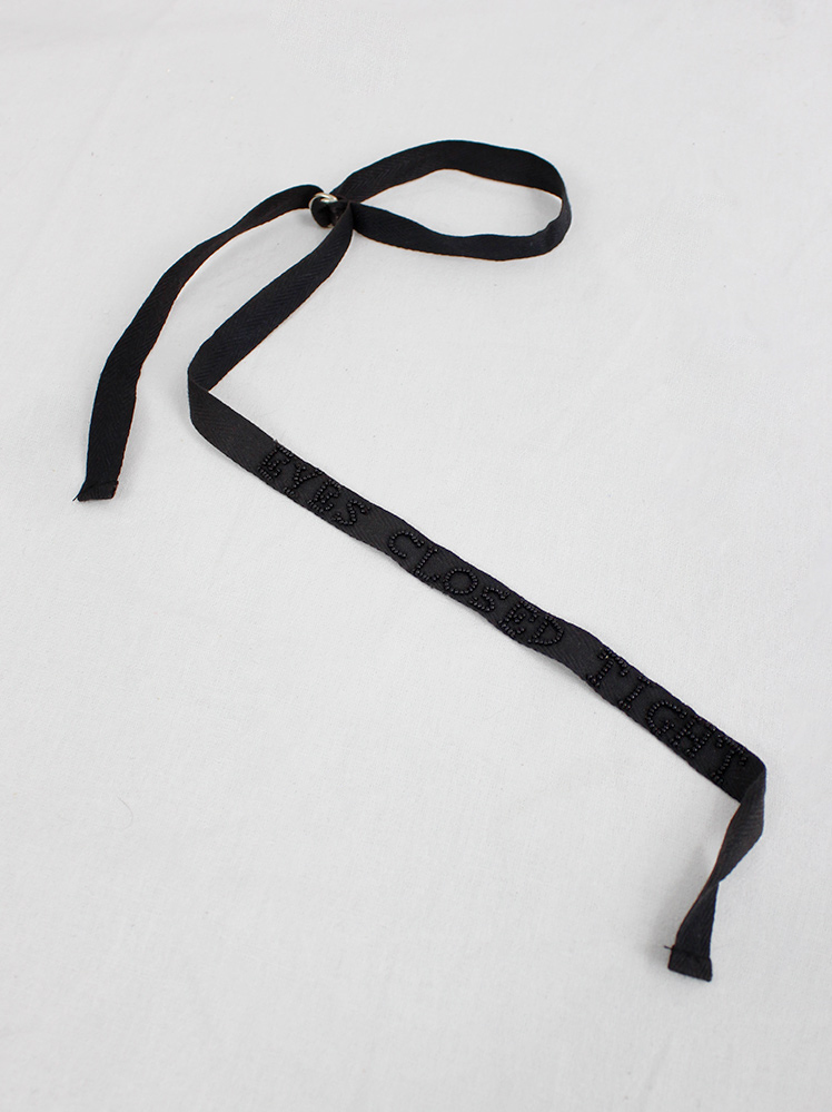 Ann Demeulemeester black ribbon accessory with 'eyes closed