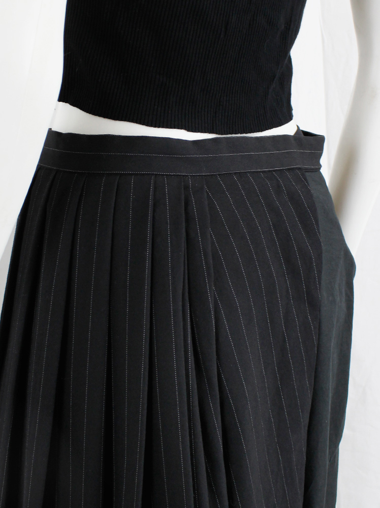 Comme des Garçons black pinstripe pleated half-skirt worn as Comme des Garçons black pinstripe pleated half-skirt worn as