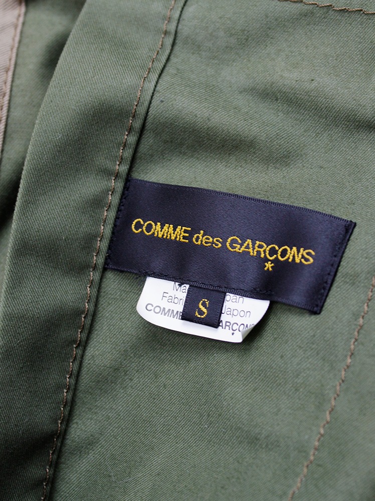 Comme des Garçons grey military jacket over a khaki green draped