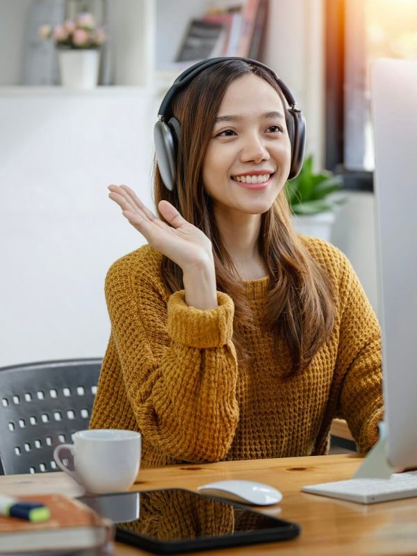 young-beautiful-asian-woman-with-headphone-sitting-at-home-office-video-call-event-with-clients-.jpg