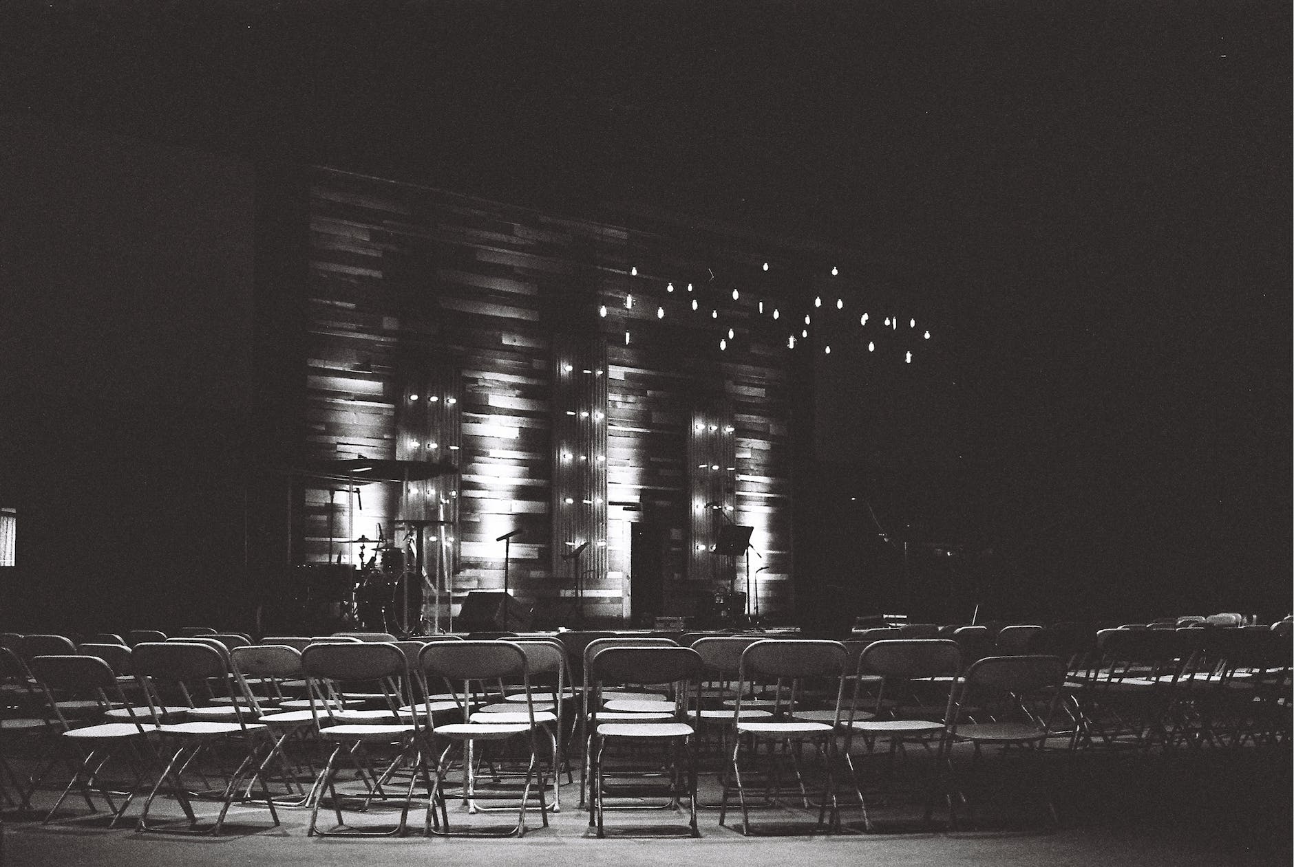 grayscale photography of chairs in an auditorium
